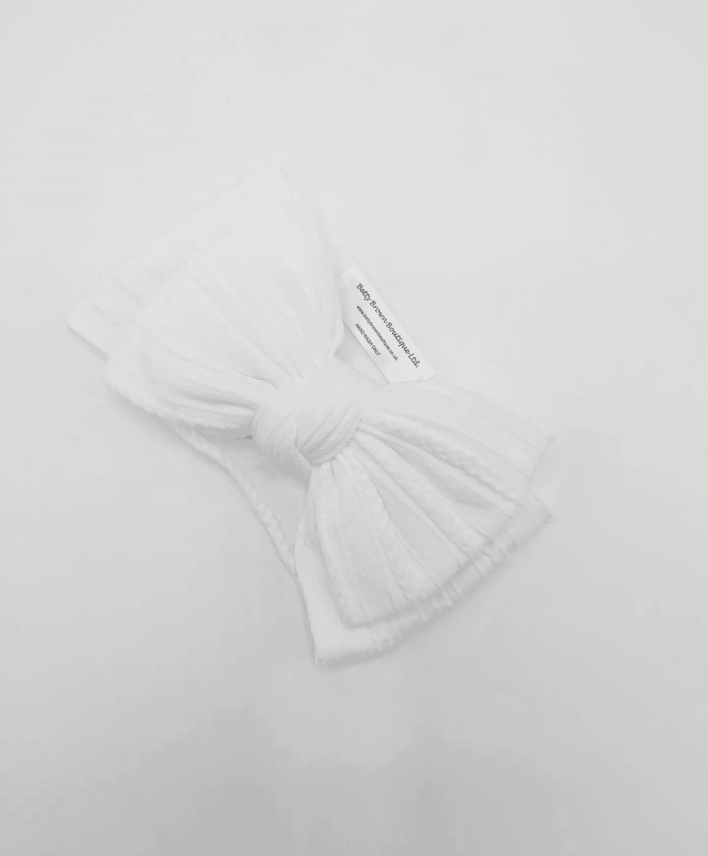 White Larger Bow Headband Designed For Newborn Babies to Age 3 - Image 5