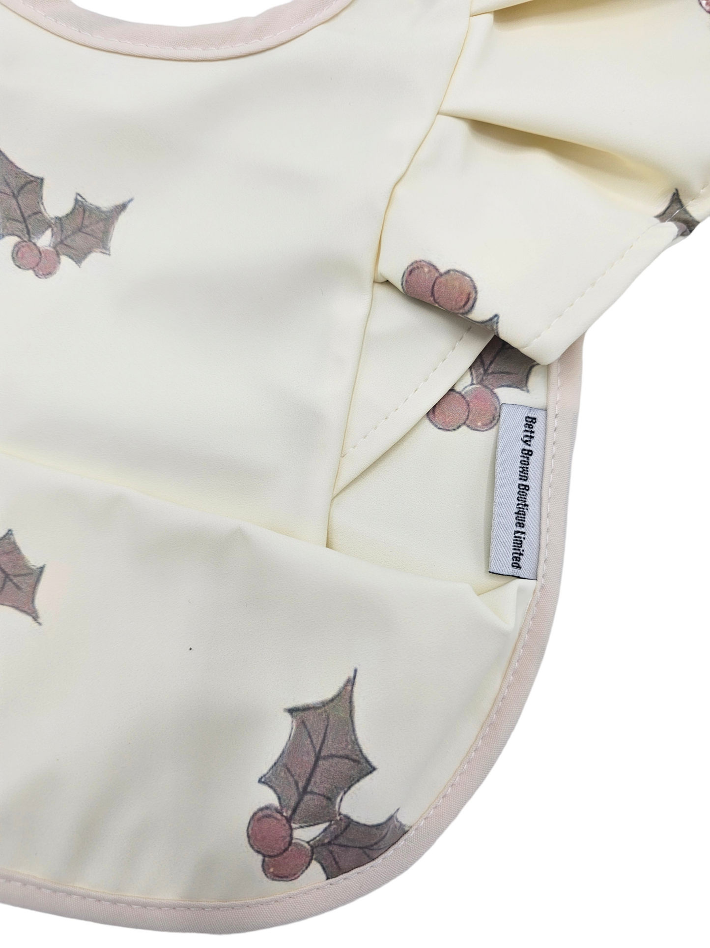 Cream Holly Print Frill Detail Waterproof Bib without Sleeves - Betty Brown Boutique Ltd