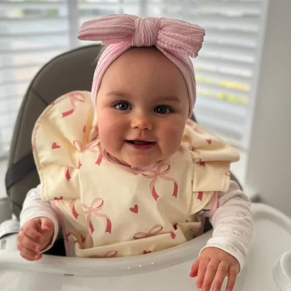 Light Pink Bow Frill Waterproof Bib For 6-18 Month Olds - Image 1