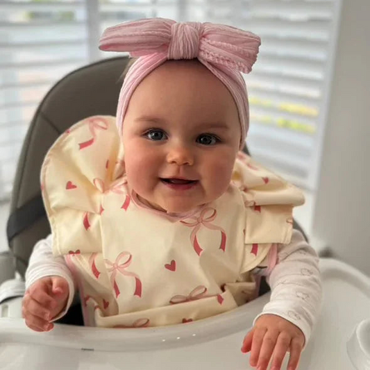 Light Pink Bow Frill Waterproof Bib For 6-18 Month Olds - Image 1