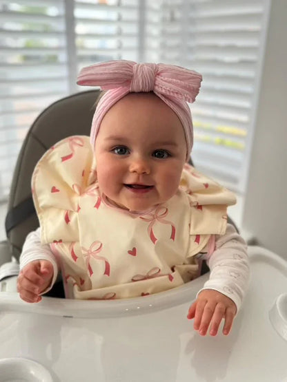 Light Pink Bow Frill Waterproof Bib For 6-18 Month Olds - Image 1