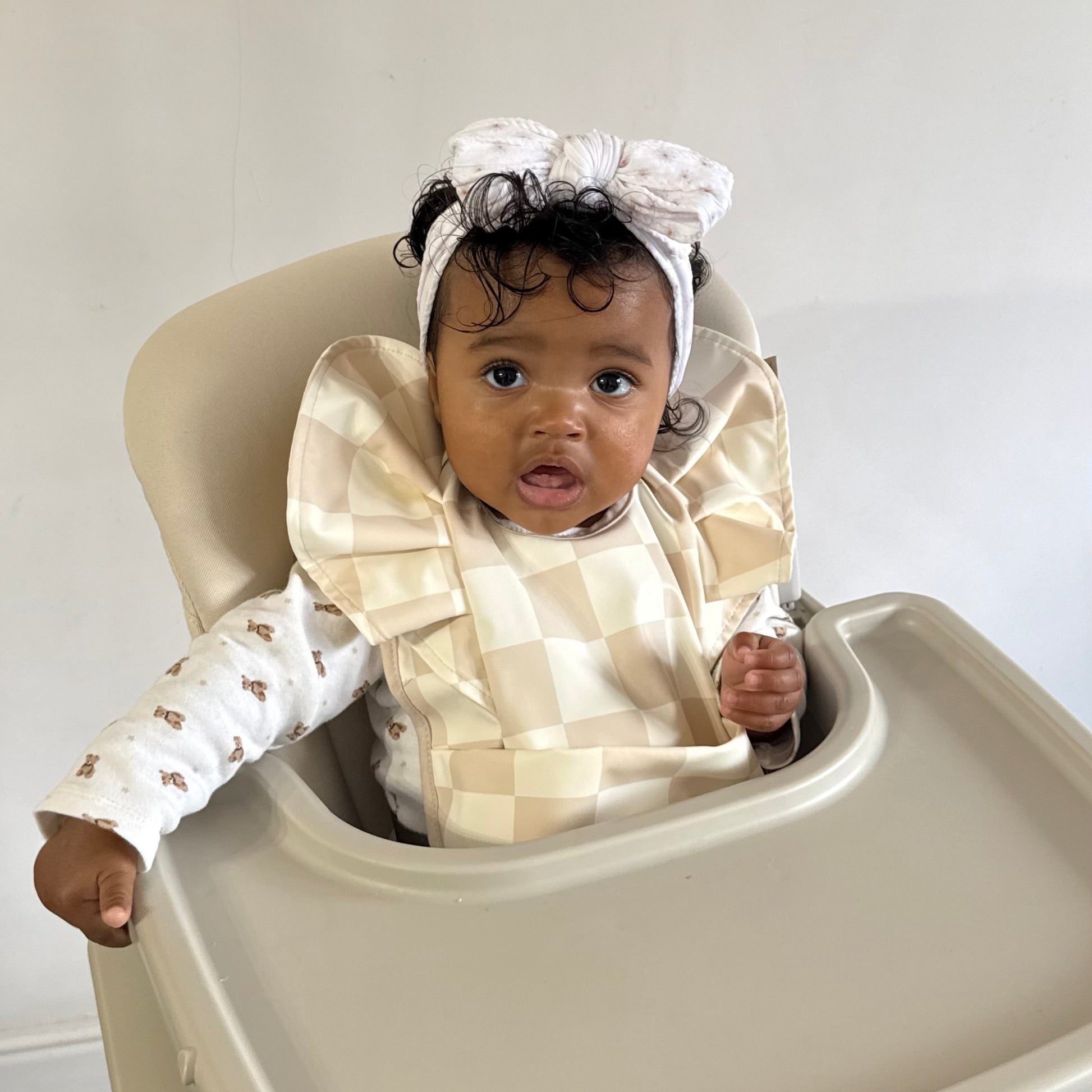 Neutral Checkered Waterproof Bib For Girls From 6-18 Months - Image 1