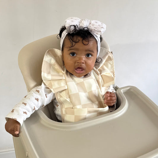 Neutral Checkered Waterproof Bib For Girls From 6-18 Months - Image 1