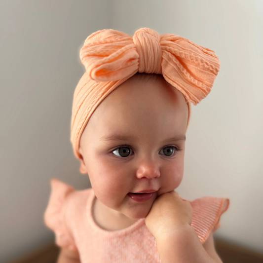 Peach Larger Bow Headband For Babies From Newborn to Age 3 - Image 1